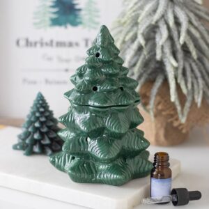Green fir tree oil burner and wax warmer, festive Christmas home decor accessory.