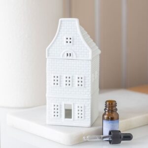 White Nordic house oil burner and wax warmer, festive Christmas home decor accessory.