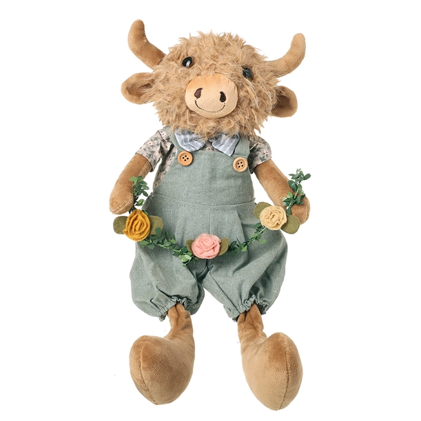 Dangly Legs Highland Cow plush wearing sage green dungarees and a floral garland with soft fluffy fur and long dangling legs.