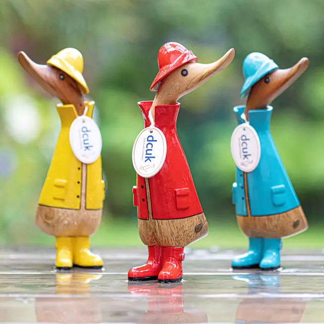 Hand-carved DCUK Rainy Day Ducklings decorative bamboo duck ornaments, individually painted colourful collectible figures in yellow, red, blue, green and pink, each approx. 22cm tall.