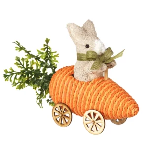 Cute rabbit ornament sitting in a carrot-shaped car with textured orange twine, wooden wheels, and leafy green accents for Easter and spring decor.