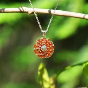 Silver plated marigold orange pendant necklace with hand enamel floral design, botanical jewellery inspired by marigold flower, orange enamel pendant on adjustable chain.