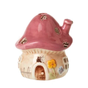 Small pink ceramic mushroom house ornament with fairy cottage design, pink mushroom roof and floral details, woodland décor piece, ideal for pairing with larger blue ceramic mushroom ornaments, 7.3cm.