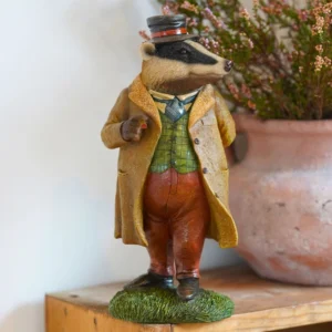 Hand-painted Master Badger resin garden ornament inspired by The Wind in the Willows, weatherproof badger statue for indoor and outdoor home and garden decor.