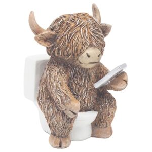 Highland cow ornament sitting on a toilet (loo) scrolling on a phone, humorous bathroom decor figurine with shaggy fur and rustic novelty design.
