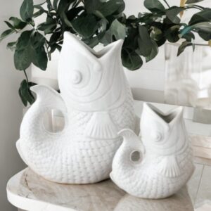 White ceramic fish vase with textured scales, sculpted fins, and open mouth vase opening, styled as a coastal-inspired decorative home accessory.