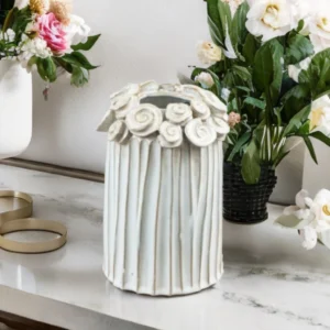 Ceramic flower vase with floral motif detailing around the rim, ideal for rustic home décor and displaying fresh or dried flowers.