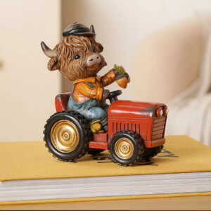Highland cow driving a red tractor resin ornament with rustic farmyard details, perfect for autumn, harvest and countryside home decor.