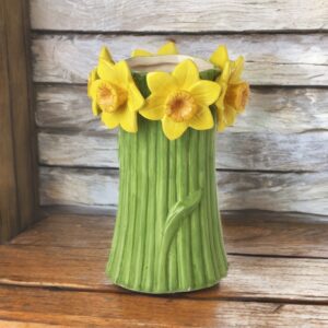 Green ceramic daffodil pot with yellow daffodil floral detailing around the top
