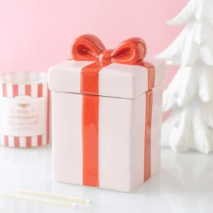 Pink ceramic present-shaped Christmas oil burner with red ribbon design