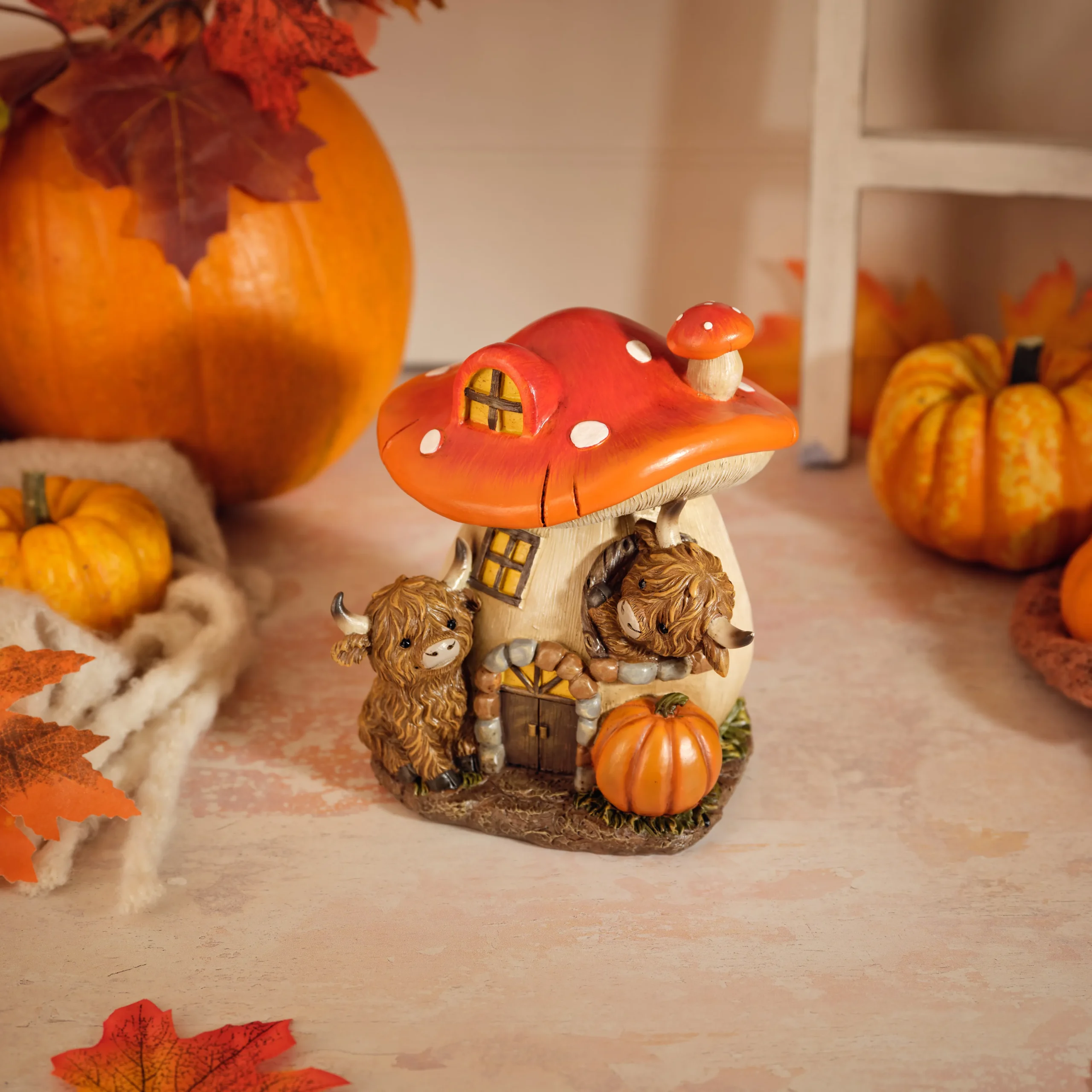 Resin mushroom house ornament with two Highland cows and vibrant red orange roof