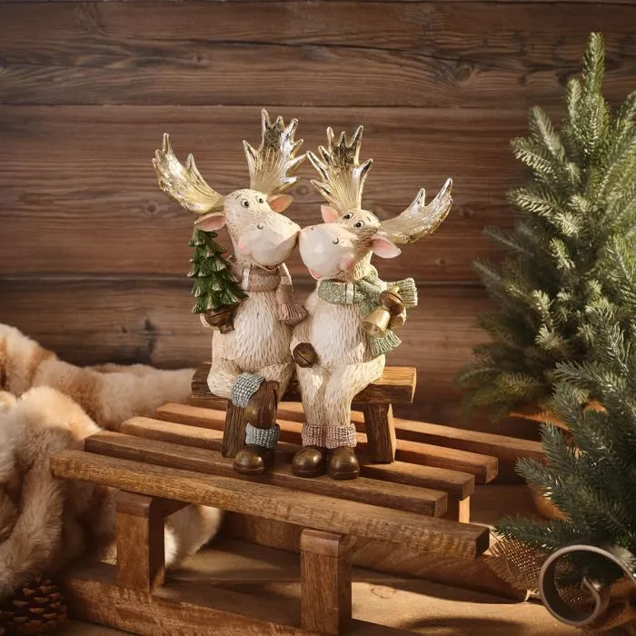 Nordic Nest resin moose couple Christmas ornament sitting on bench with gold antlers